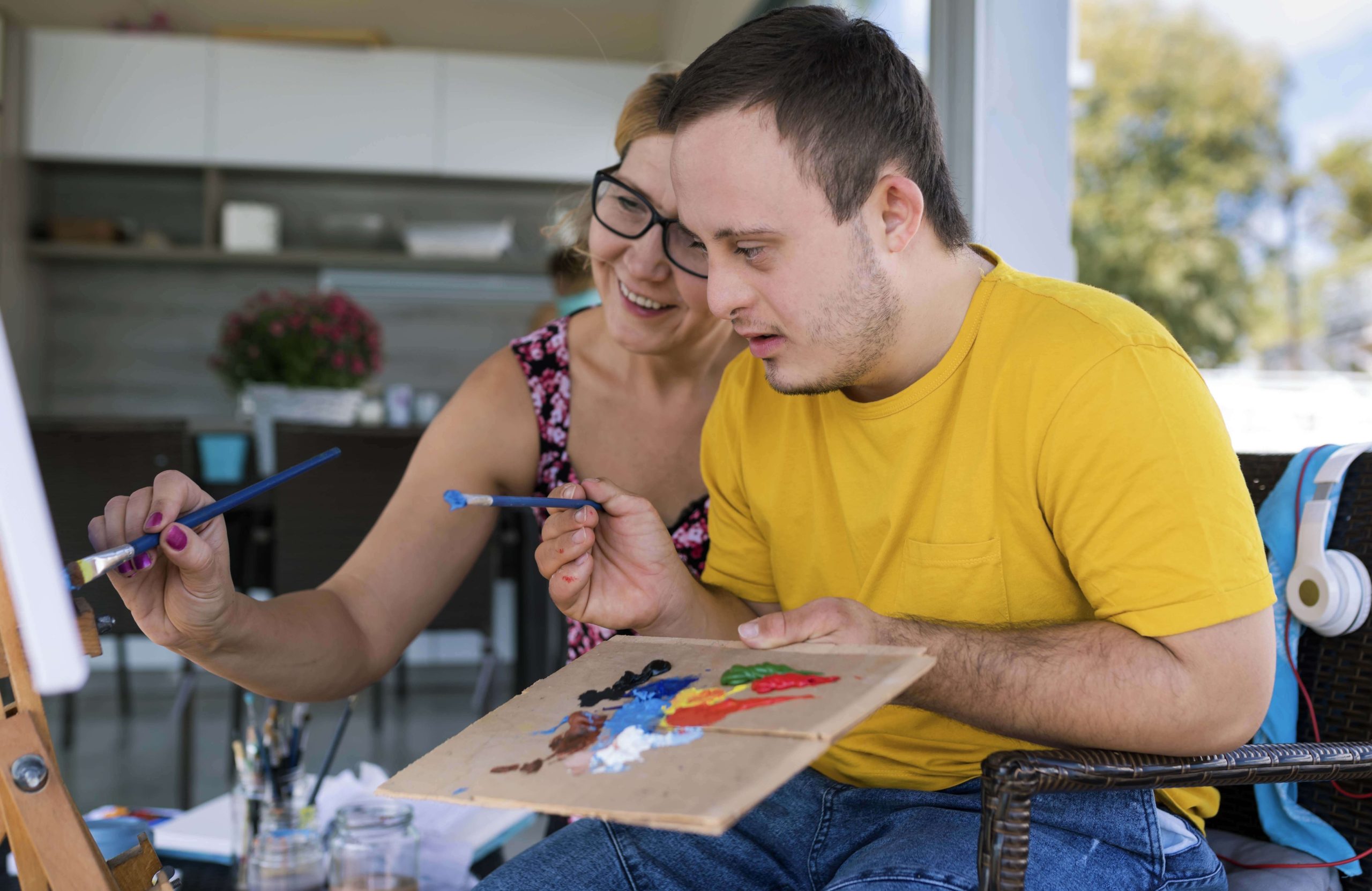 man painting with care lady